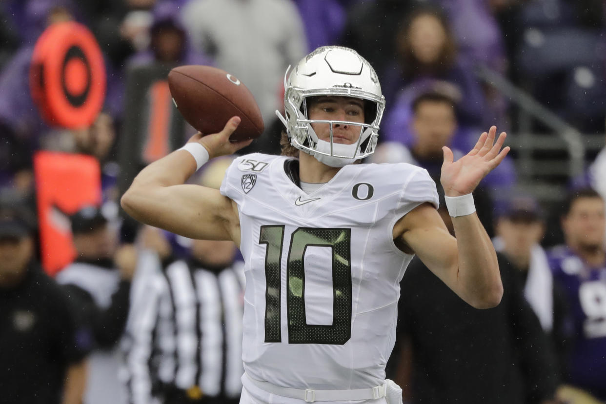 Oregon quarterback Justin Herbert passes against Washington in the first half of an NCAA college football game Saturday, Oct. 19, 2019, in Seattle. (AP Photo/Elaine Thompson)