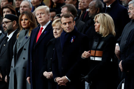 Brigitte Macron, French President Emmanuel Macron, German Chancellor Angela Merkel, U.S. President Donald Trump and first lady Melania Trump attend a commemoration ceremony for Armistice Day, 100 years after the end of the First World War at the Arc de Triomphe in Paris, France, November 11, 2018. REUTERS/Benoit Tessier/Pool