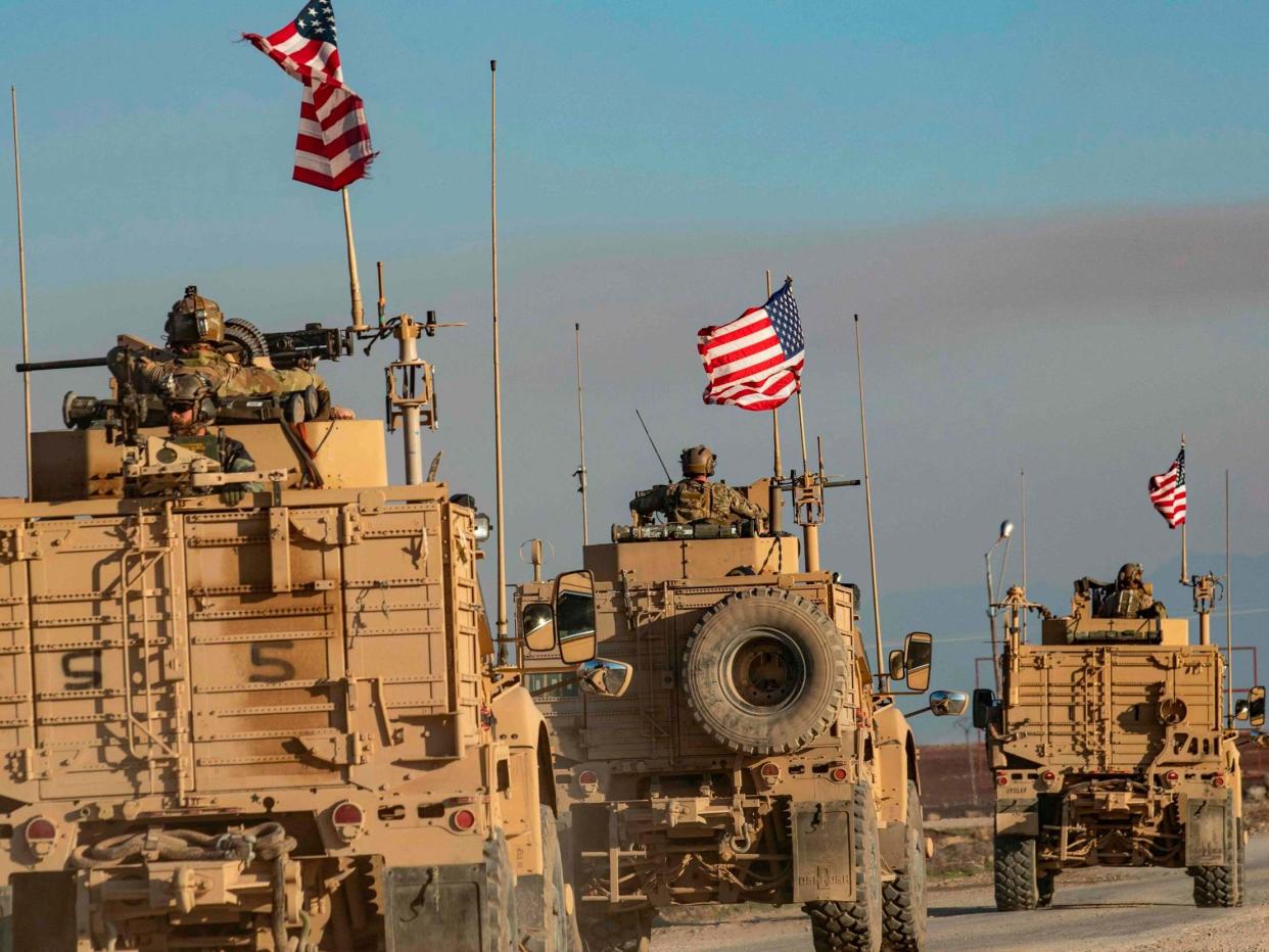 A convoy of US armoured vehicles patrols the village of Ein Diwar in Syria's northeastern Hasakeh province: DELIL SOULEIMAN/AFP via Getty Images