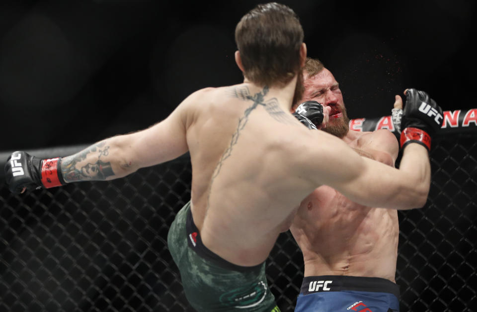Conor McGregor kicks Donald "Cowboy" Cerrone during a UFC 246 welterweight mixed martial arts bout Saturday, Jan. 18, 2020, in Las Vegas. (AP Photo/John Locher)