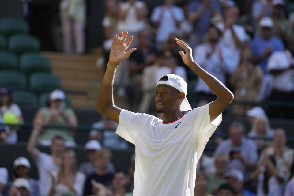 Christopher Eubanks of the US celebrates defeating Britain's Cameron Norrie in the men's singles match on day five of the Wimbledon tennis championships in London, Friday, July 7, 2023. (AP Photo/Alastair Grant)