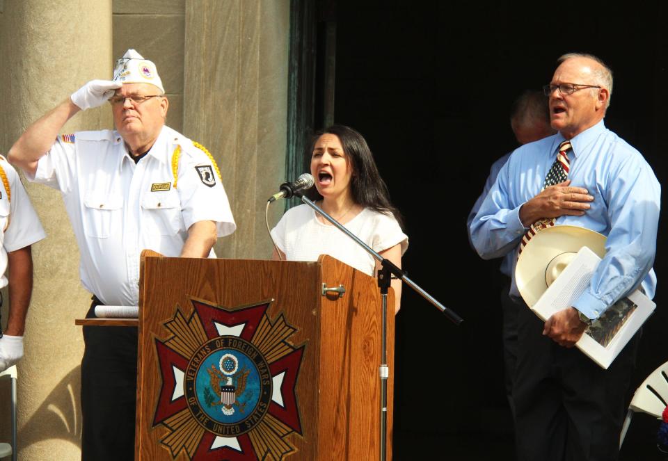 Lindsey Studnicki sings the national anthem at the Memorial Day service Monday at Southside Cemetery.