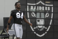Oakland Raiders' Antonio Brown walks on the field while stretching during NFL football practice in Alameda, Calif., Tuesday, Aug. 20, 2019. (AP Photo/Jeff Chiu)