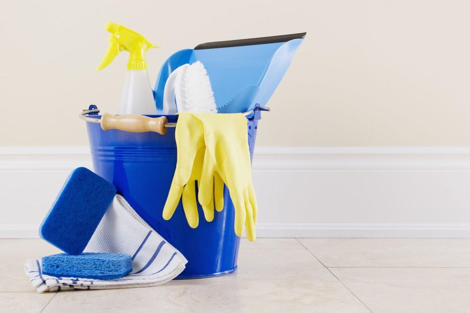 Organize cleaning supplies in a caddy.