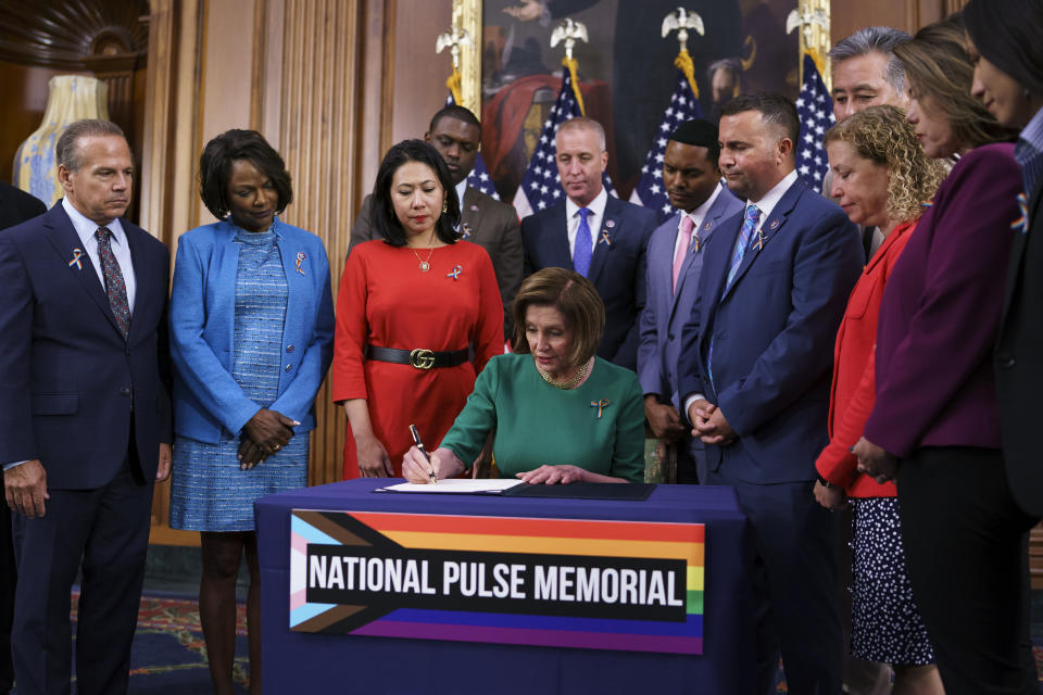 House Speaker Nancy Pelosi, D-Calif., joined by, from left, Rep. David Cicilline, D-R.I., Rep. Val Demings, D-Fla., Rep. Stephanie Murphy, D-Fla., Speaker Pelosi, Rep. Darren Soto, D-Fla., and Rep. Debbie Wasserman Schultz, D-Fla., signs the bill to create the National Pulse Memorial to honor the victims of the 2016 mass shooting at the Pulse nightclub in Orlando, at the Capitol in Washington, Wednesday, June 16, 2021. The shooting was the deadliest attack on the LGBTQ community in U.S. history and left 49 people dead. (AP Photo/J. Scott Applewhite)