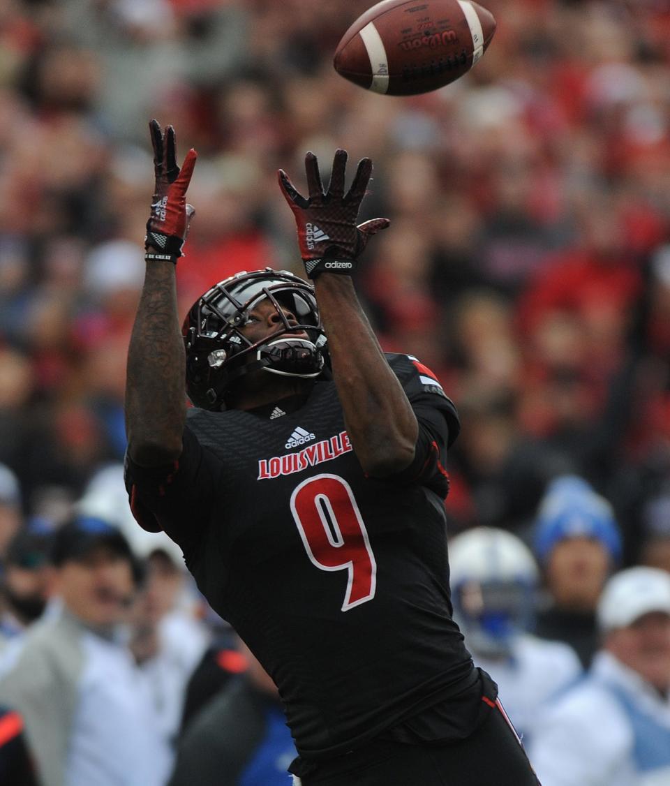 Louisville's DeVante Parker catches a touchdown pass from quarterback Kyle Bolin against the Wildcats.