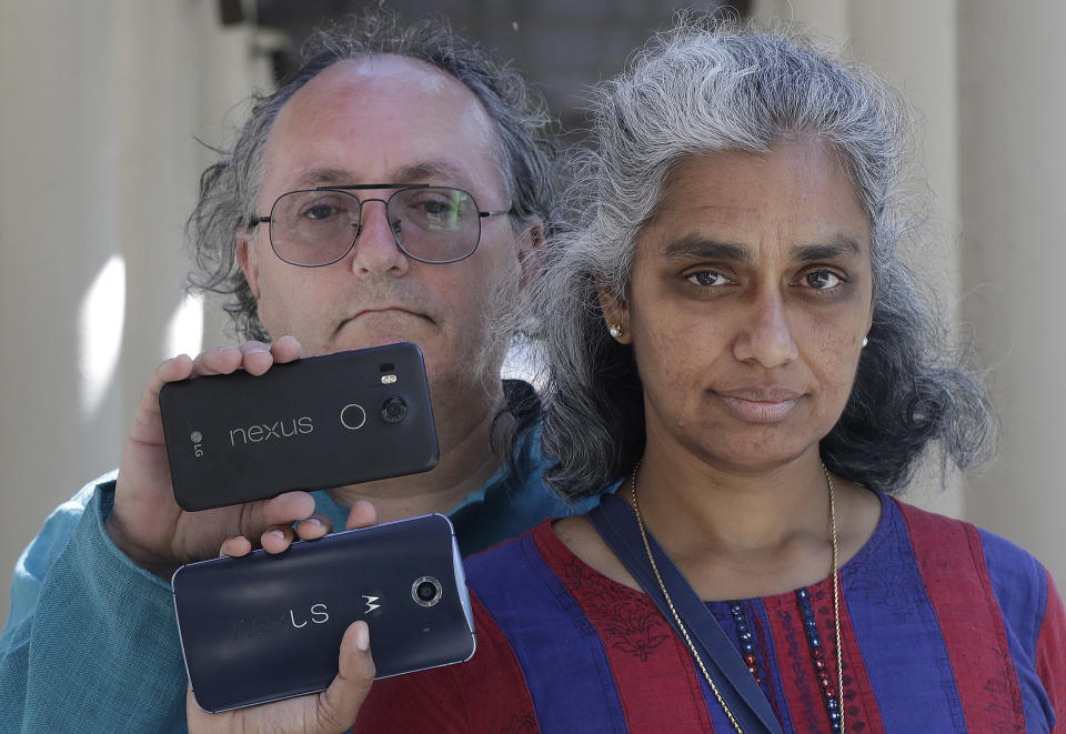 In this July 25, 2018 photo, Kalyanaraman Shankari, right, and her husband Thomas Raffill hold their phones while posing for photos in Mountain View, Calif. An Associated Press investigation shows that using Google services on Android devices and iPhones allows the search giant to record your whereabouts as you go about your day. Shankari, a graduate researcher at UC Berkeley who connects commuting patterns with urban planners, noticed that her Android phone prompted her to rate a shopping trip to Kohl’s. That happened even though she had turned off Google’s “location history” setting, which according to the company should prevent it from remembering where a user has been. (AP Photo/Jeff Chiu)