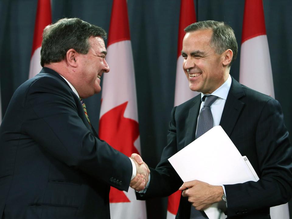 Canadian Finance Minister Jim Flaherty, left, shakes hands with Bank of Canada Governor Mark Carney, right, in Ottawa, Ontario, Monday Nov. 26, 2012. Carney will become head of the Bank of England next summer. Flaherty called it a bittersweet moment as he announced Carney's new job as the first time a foreigner has been tabbed to run Britain's venerable national bank. (AP Photo/The Canadian Press, Fred Chartrand)