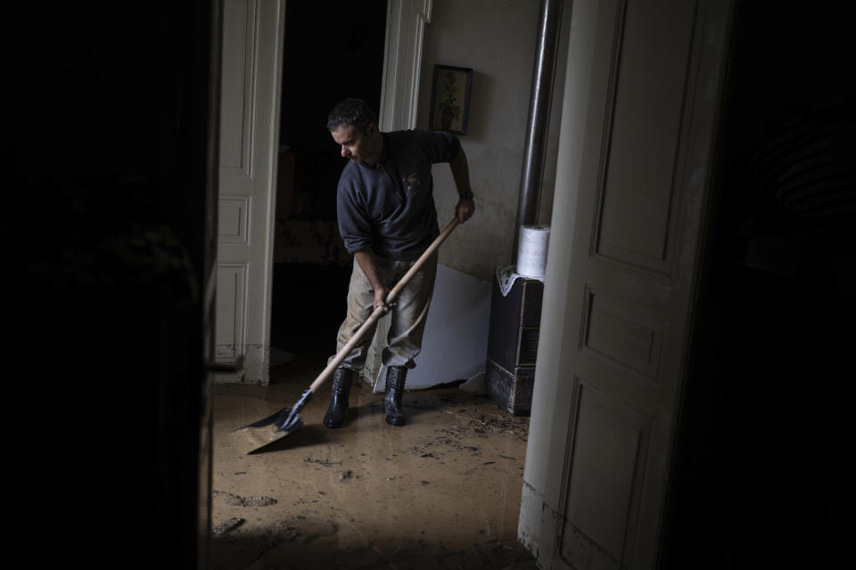 Apostolis Sirtariotis, 47, shovels muddy water from his flooded home in the storm-hit city of Volos, Greece, where power and water outages remained in some districts, on Friday, Sept. 29, 2023. Bad weather has eased in central Greece leaving widespread flooding and infrastructure damage across the farming region that has been battered by two powerful storms in less than a month. (AP Photo/Petros Giannakouris)