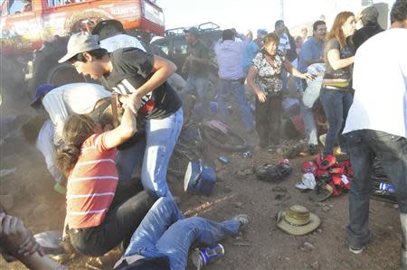 Spectators react after a monster truck rammed the stand where they were watching a monster truck rally show at El Rejon park, on the outskirts of Chihuahua October 5, 2013. REUTERS/Eduardo Alanis/El Diario de Chihuahua