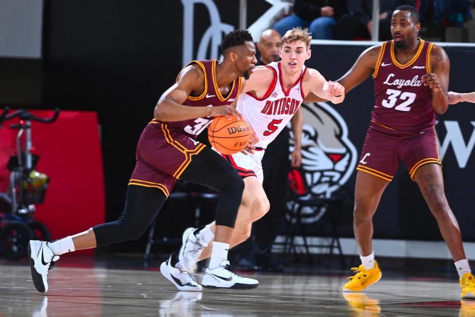 Davidson men’s basketball senior Grant Huffman defends a Loyola Chicago player on Senior Night on Tuesday, March 6, 2024, in John M. Belk Arena. TIM COWIE