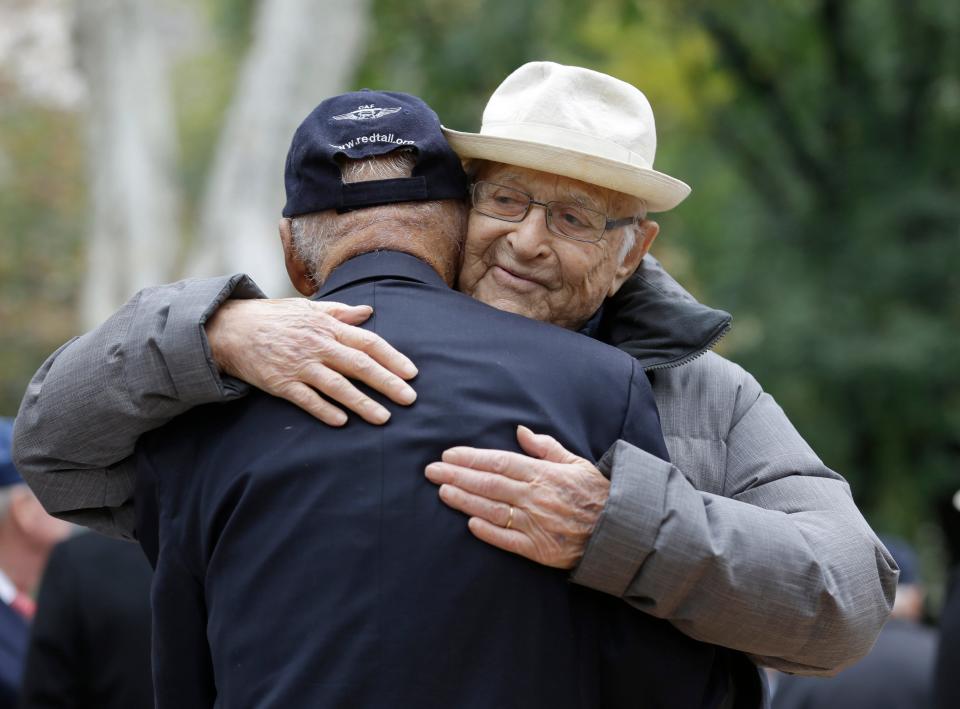 Television writer and veteran Norman Lear embraces Tuskegee Airmen Roscoe Brown during the 2015 Veterans Day parade in New York. The two served in the air force at the same time during World War II.