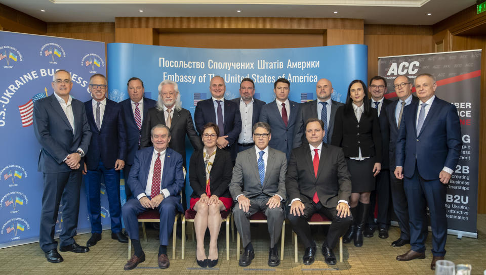 In this Nov. 12, 2018, photo provided by the U.S. Embassy in Kyiv, Energy Secretary Rick Perry poses for a photo after speaking at in Kyiv, Ukraine, with front row from left, Morgan Williams, then-U.S. Ambassador to Ukraine Marie Yovanovitch and president of the American Chamber of Commerce in Ukraine Andy Hunder. Also pictured are Alex Cranberg, top second from left and Michael Bleyzer, top row forth from left. Bleyzer and Cranberg, two political supporters of Perry secured a potentially lucrative oil-and-gas exploration deal from the Ukrainian government soon after Perry proposed one of the men as an adviser to the country’s new president. (U.S. Embassy Kyiv via AP)