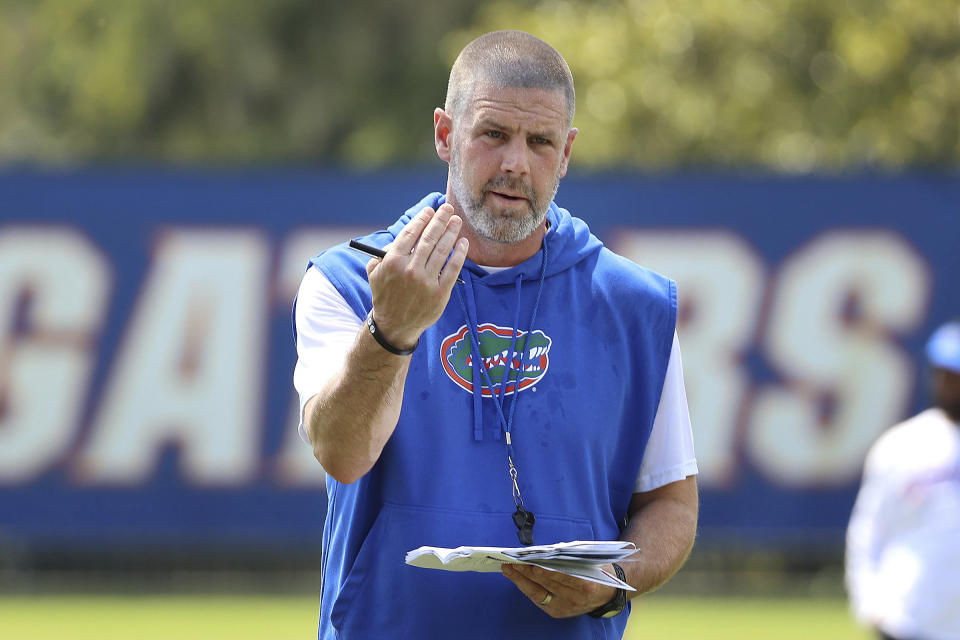 FILE - Florida head football coach Billy Napier runs players through drills during NCAA college football practice in Gainesville, Fla., Aug. 1, 2023. (Stephen M. Dowell/Orlando Sentinel via AP, File)