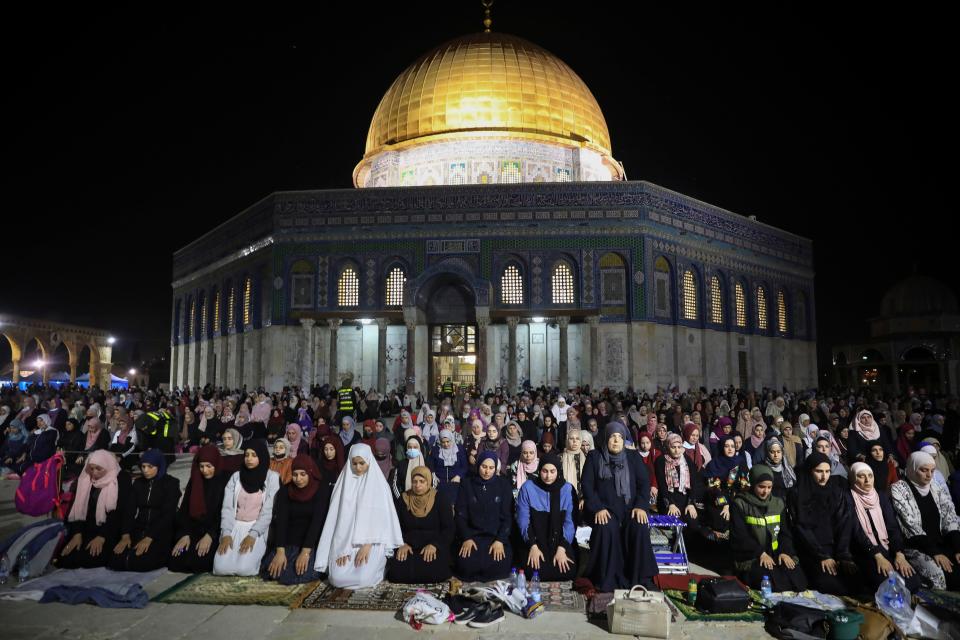 Palestinian Muslim worshippers pray during the Laylat al-Qadr, or the night of destiny, the holiest night of Ramadan, in front of the Dome of the Rock Mosque at the Al Aqsa Mosque compound May 8, 2021.