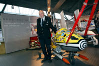 Kenneth Wallis poses for photographers with his invention, Little Nellie, at the opening of a press preview of the Bond in Motion exhibition at the Beaulieu National Motor Museum at Brockenhurst in the southern English county of Hampshire on January 15, 2012. The Bond in Motion exhbition features fifty original iconic vehicles used in the James Bond films to celebrate fifty years of 007 and will open to the public from January 17. AFP PHOTO/ JUSTIN TALLIS