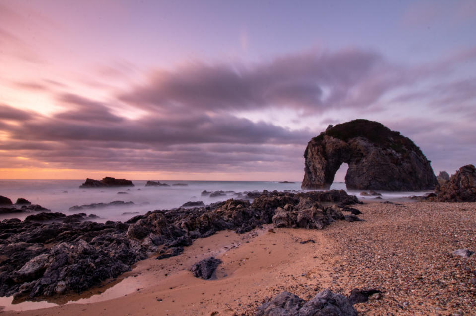 A collection of rocks on a beach overlooking the water