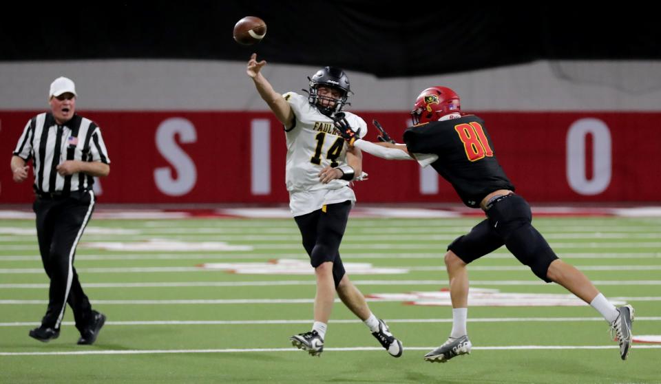 Avon's Trace Pelton pressures Faulkton Area quarterback Layne Cotton during the state Class 9B football championship on Thursday, Nov. 9, 2023 in Vermillion's DakotaDome. Avon won 32-30. At left is referee David Planteen of Langford.