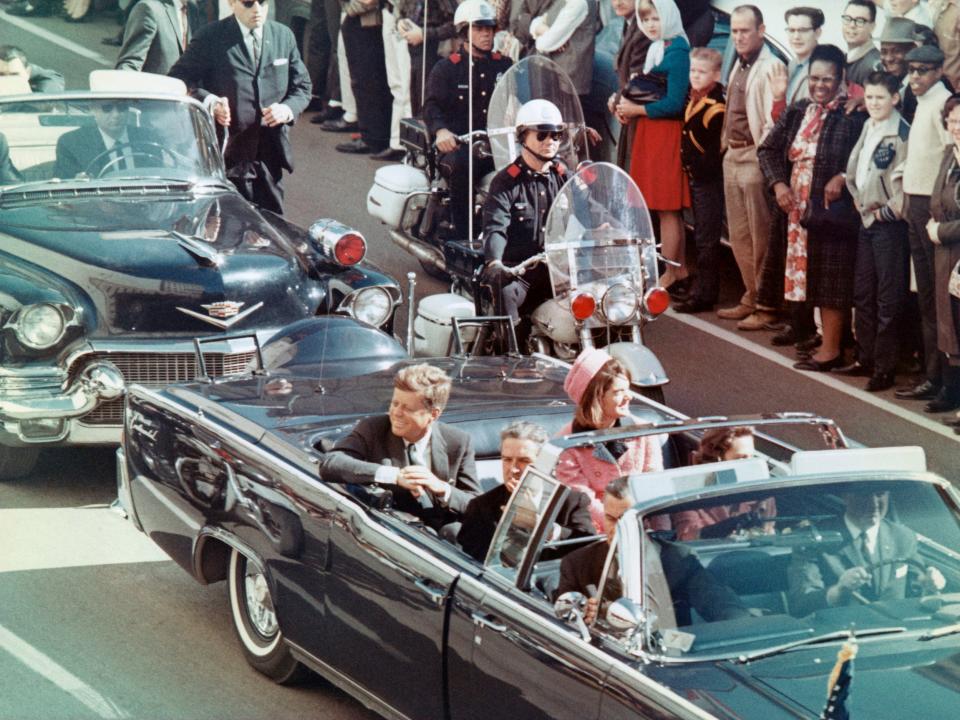 President John F. Kennedy and his wife Jackie in a motorcade passing through through Dealey Plaza in 1963.