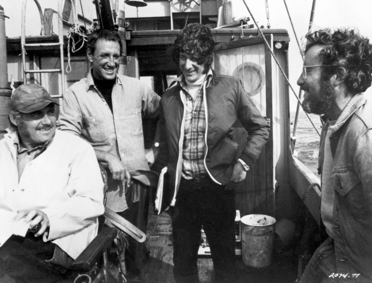 1975, British actor Robert Shaw, American actor Roy Scheider, American director Steven Spielberg, and American actor Richard Dreyfuss laugh together on a boat during the filming of Spielberg's 'Jaws'. (Photo by Universal Studios/Getty Images)