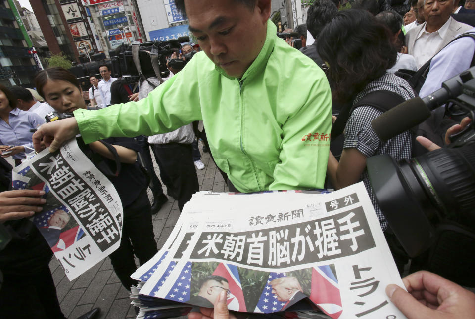 In this June 12, 2018, file photo, a staff of a local newspaper Yomiuri distributes an extra edition of the newspaper reporting about the summit between U.S. President Donald Trump and North Korean leader Kim Jong Un in Singapore, at Shimbashi Station in Tokyo. Trump and Kim are planning a second summit in the Vietnam capital of Hanoi, Feb. 27-28. (AP Photo/Koji Sasahara, File)