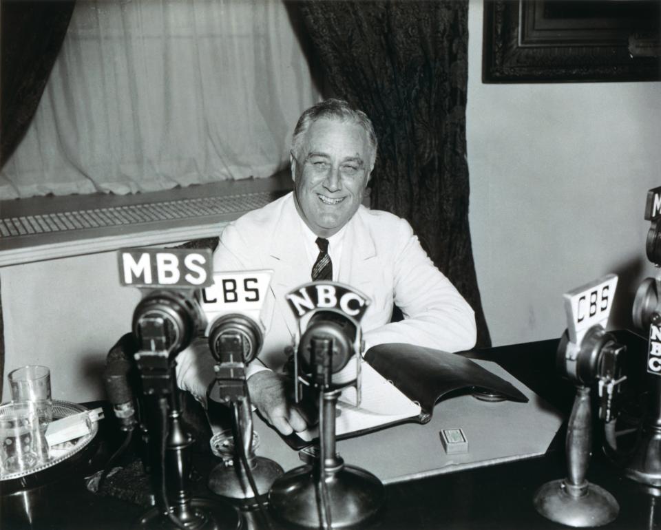 In this black and white photograph by Harris and Ewing, President Franklin D. Roosevelt delivers his 13th Fireside chat describing the accomplishments of the 75th Congress, progress that has been made relating to the Great Depression, and the upcoming 1938 elections.