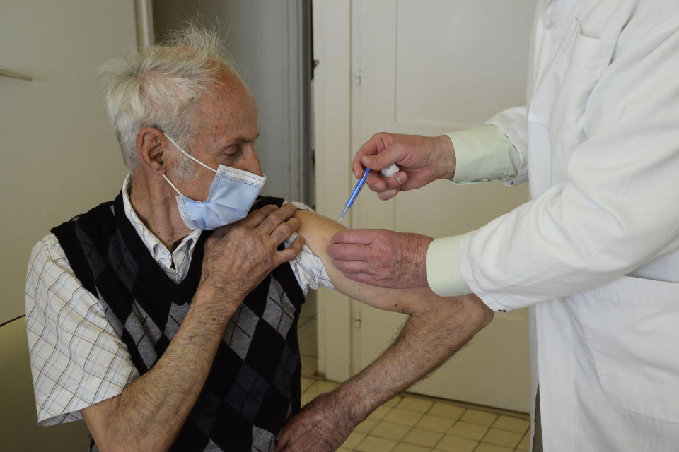 FILE - In this April 1, 2021, file photo, general practitioner Gyorgy Teleki vaccinates an elderly patient with the second dose of COVID-19 vaccine produced by Chinese Sinopharm in Taplanszentkereszt, Hungary. A new study suggests that a Sinopharm vaccine offers poor protection from COVID-19 among the elderly, raising questions for dozens of countries that have given the Chinese company’s shots to their most vulnerable populations. (Istvan Filep/MTI via AP, File)