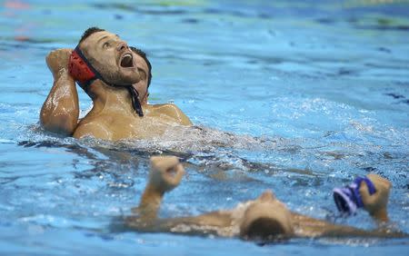 2016 Rio Olympics - Water Polo - Final - Men's Gold Medal Match Croatia v Serbia - Olympic Aquatics Stadium - Rio de Janeiro, Brazil - 20/08/2016. Members of the Serbia team celebrate their gold medal win. REUTERS/Damir Sagolj