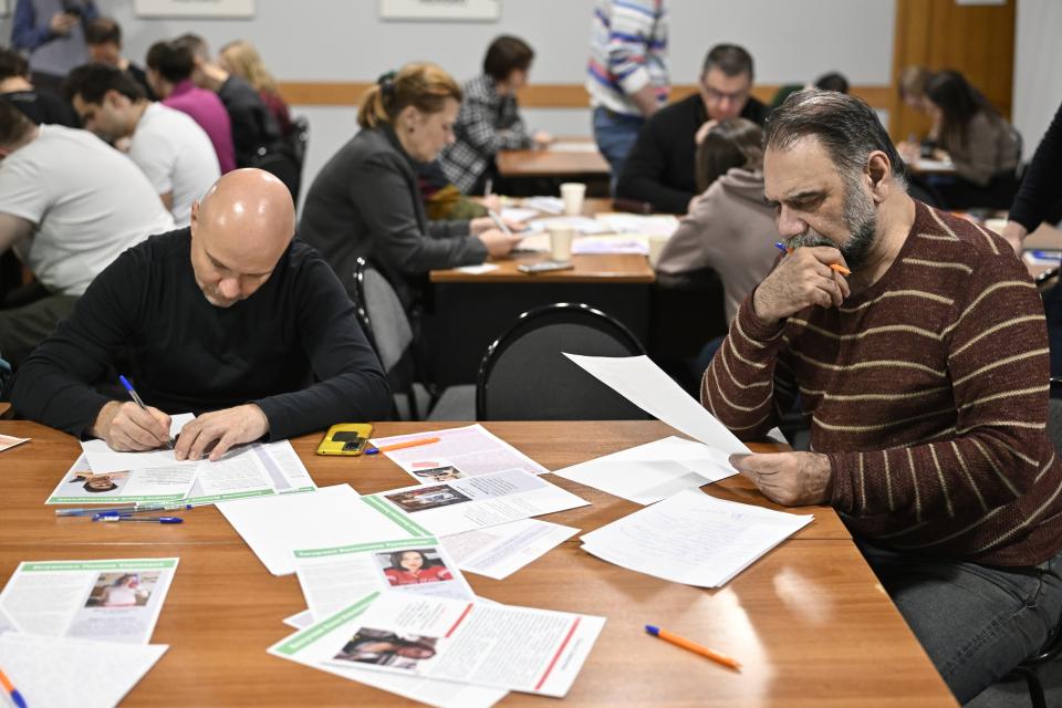 Muscovites write letters to political prisoners at the office of the liberal party Yabloko in Moscow, Russia, Thursday, Feb. 29, 2024. Yabloko hosts monthly letter-writing evenings in cities across Russia. With protests all but stifled, more and more Russians at home and abroad are seeking to channel their activism by writing letters to political prisoners. (AP Photo/Dmitry Serebryakov)