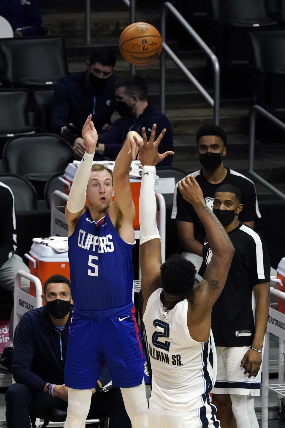 Los Angeles Clippers guard Luke Kennard (5) shoots over Memphis Grizzlies center Xavier Tillman (2) during the first half of an NBA basketball game Wednesday, April 21, 2021, in Los Angeles. (AP Photo/Marcio Jose Sanchez)