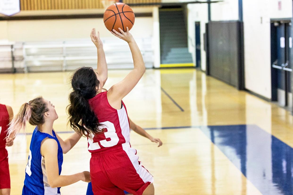 Diverse high school female basketball team playing a game