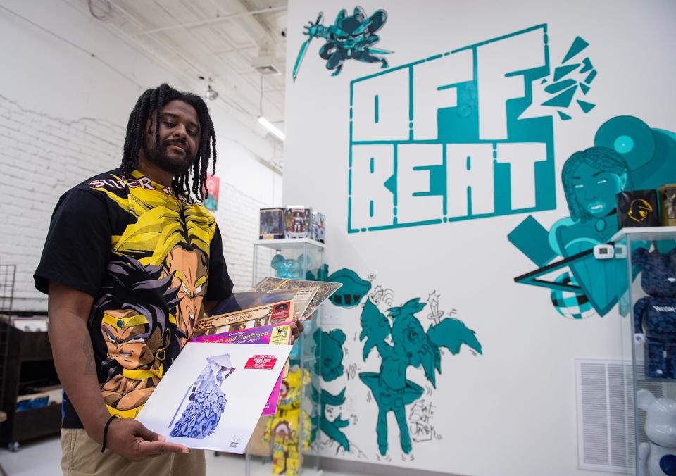 Phillip Rollins, Offbeat owner, holds out some of the Record Store Day vinyls he is most excited for at Offbeat in Jackson, Miss., on Tuesday, April 9, 2024. Rollins is also excited for the Bobby Rush vinyl that will be released, but he has not received that shipment yet.