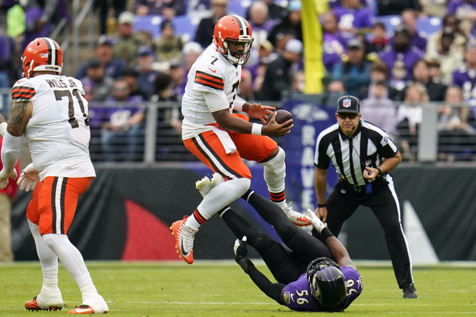 Cleveland Browns quarterback Jacoby Brissett (7) avoids Baltimore Ravens linebacker Josh Bynes (56) in the second half of an NFL football game, Sunday, Oct. 23, 2022, in Baltimore. (AP Photo/Julio Cortez)