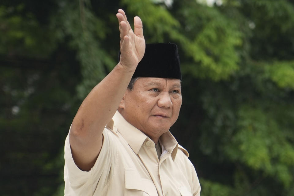 Indonesian Defense Minister and presidential frontrunner Prabowo Subianto waves at supporters after a visit to his father's grave in Jakarta, Indonesia Thursday, Feb. 15, 2024. The wealthy ex-general looks set to be the country's next president after unofficial tallies showed him taking a clear majority in the first round of voting. (AP Photo/Tatan Syuflana)