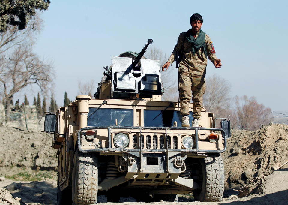 An Afghan security force member stands guard near the site of an incident where two U.S. soldiers were killed earlier in February, in Nangarhar province, Afghanistan. (Reuters/Parwiz)