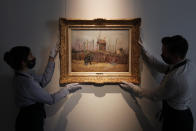 Sotheby's personnel display « Scene de rue à Montmartre » (Street scene in Montmartre), a painting by Dutch master Vincent van Gogh at Sotheby's auction house in Paris, Thursday, Feb. 25, 202. The artwork painted in 1887 is to be on public display for the first time ahead of an auction next month. It has remained in the same family collection for over 100 years, according to the auction house which did not reveal the identity of the owner. (AP Photo/Christophe Ena)