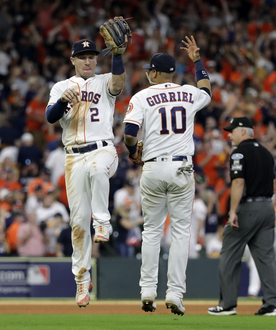 Houston Astros' Alex Bregman (2) and Yuli Gurriel (10) celebrate their win over Cleveland Indians in Game 2 of a baseball American League Division Series, Saturday, Oct. 6, 2018, in Houston. (AP Photo/David J. Phillip)