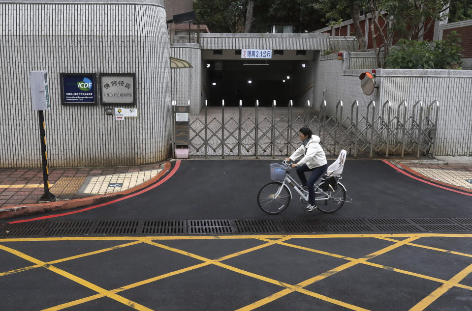 A woman rides a bicycle past the the Diplomatic Quarter building in Taipei, Taiwan, Monday, Jan. 15, 2024. The Pacific Island nation of Nauru says it is switching diplomatic recognition from Taiwan to China. The move on Monday leaves Taiwan with 12 diplomatic allies around the world. Taiwan now has official ties with 11 countries and the Vatican. (AP Photo/Chiang Ying-ying)