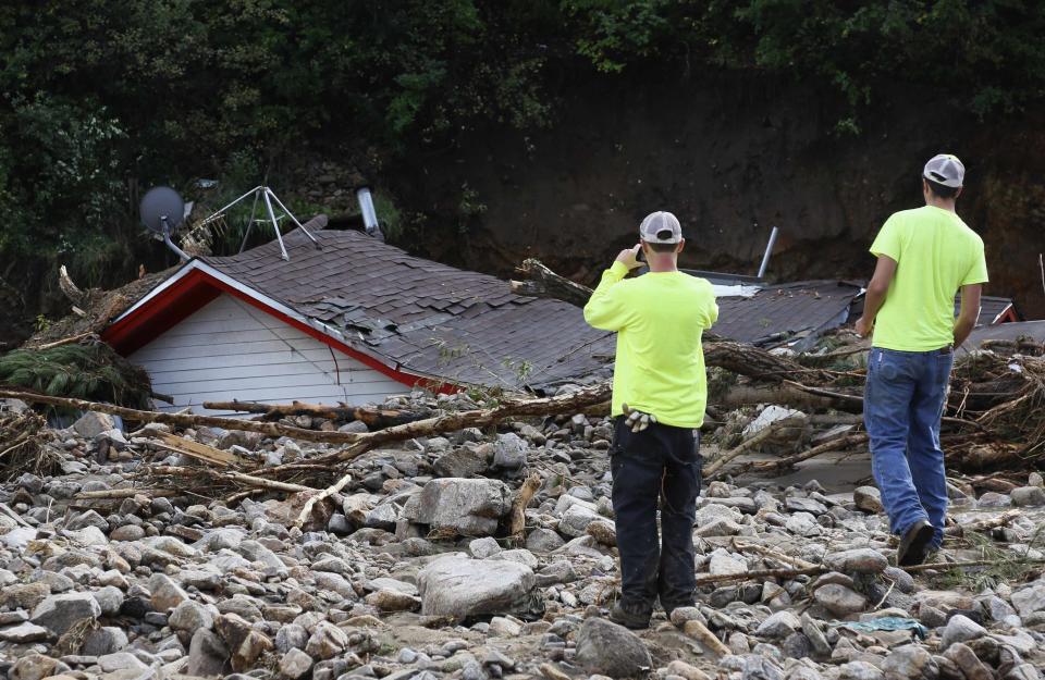 Boulder County workers look at a destroyed house in Jamestown, Colorado