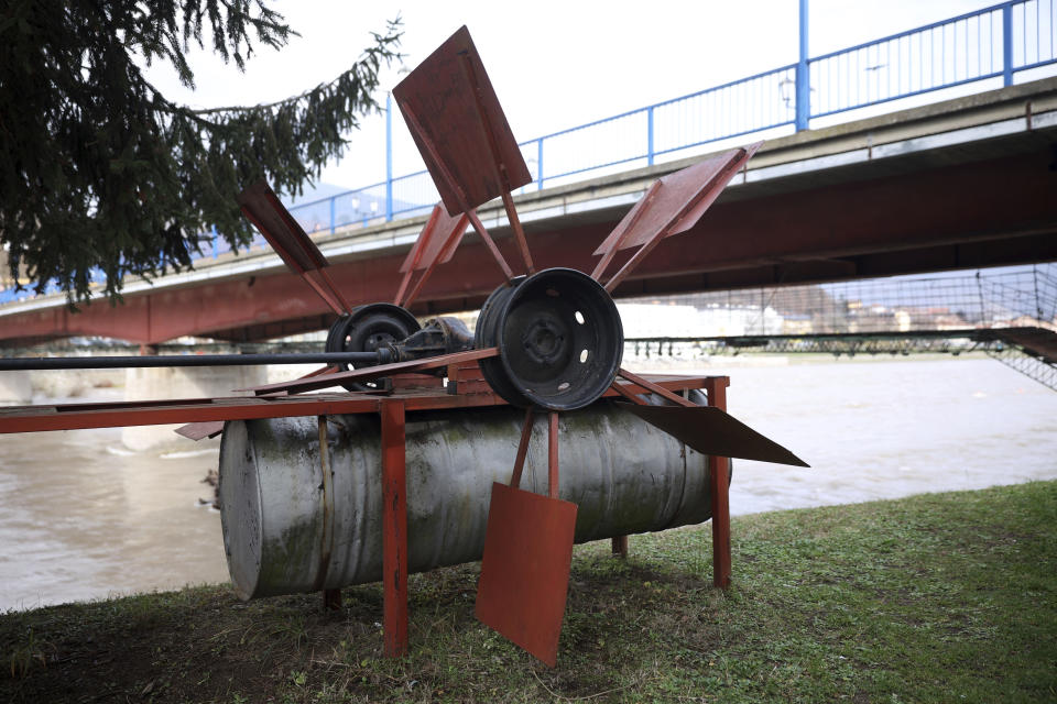 Improvised hydropower plant which now serves as a monument in seen on the bank of Drina river in Gorazde, Bosnia, Monday, Dec. 19, 2022. To survive and keep the lights on in their besieged town - cut off throughout Bosnia's 1992-95 interethnic war from access to electricity grid, food, medicine and the outside world - the people of Gorazde had to come up with various creative inventions. (AP Photo/Armin Durgut)