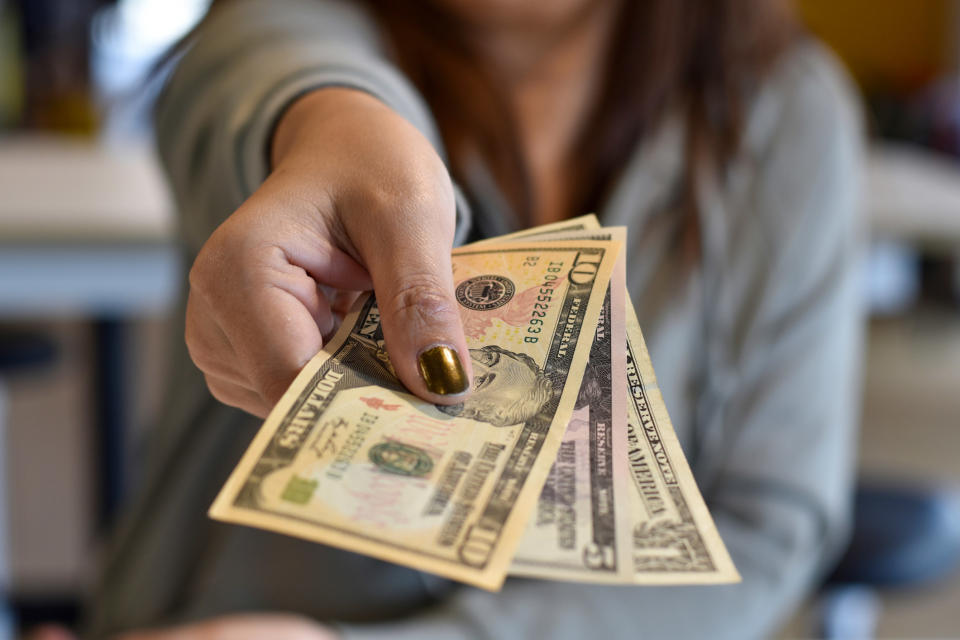 close up of someone handing over cash