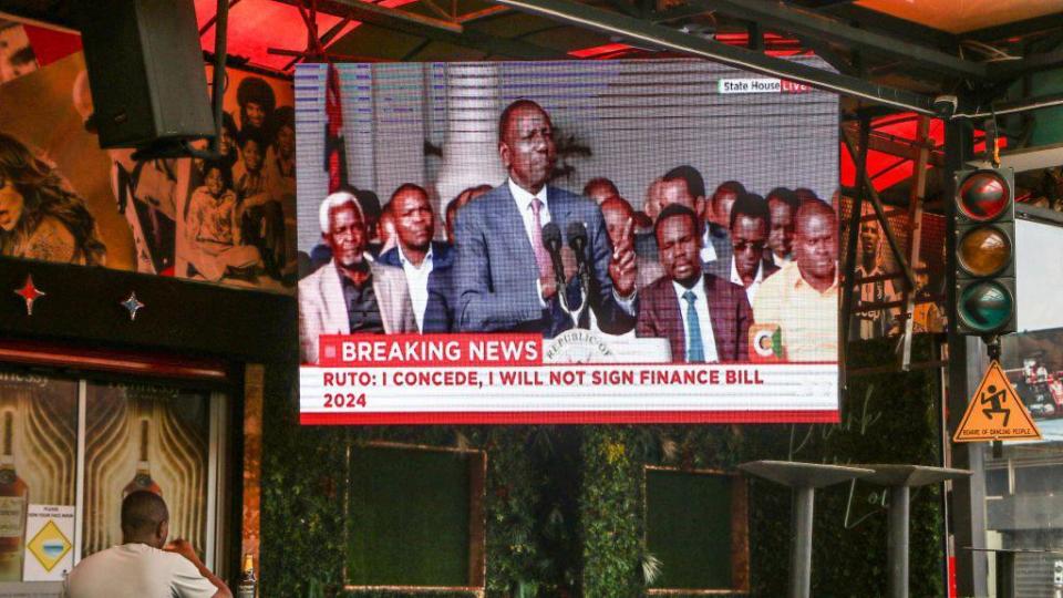 A man watches as President William Ruto gives a televised address at State House in Nairobi 