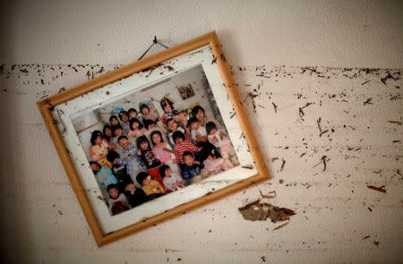 A picture frame and water marks are seen at a wall of a kindergarten destroyed by the March 11 earthquake and tsunami in Ishinomaki, northern Japan, in this April 7, 2011 file photo. REUTERS/Carlos Barria/Files