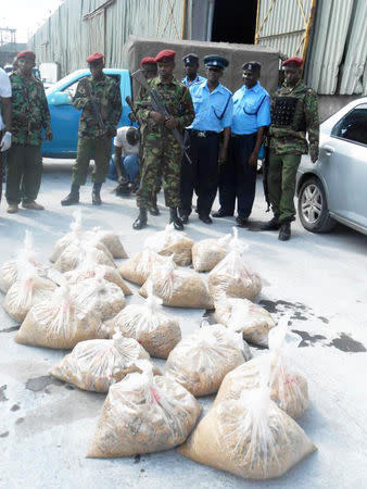 Kenyan policemen in Mombasa August 29, 2014, guard bags of heroin discovered hidden in the vessel Mv Bushehr which had been seized by the Kenya Navy in the Indian Ocean. REUTERS/Stringer