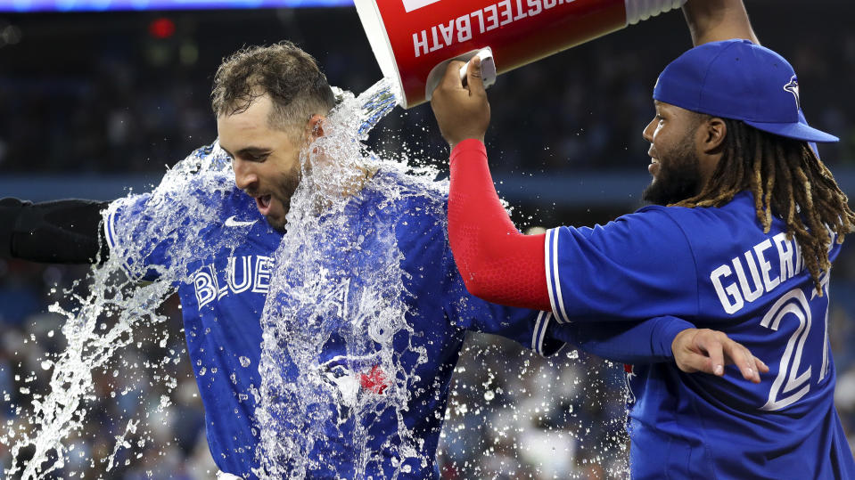 Toronto Blue Jays outfielder George Springer (4) gets doused with water from Vladimir Guerrero Jr. (27) after Toronto beat the Cardinals on Tuesday. (Richard Lautens/Toronto Star via Getty Images)