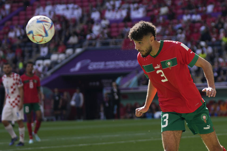 Morocco's Noussair Mazraoui heads the ball during the World Cup group F soccer match between Morocco and Croatia at the Al Bayt Stadium in Al Khor, Qatar, Wednesday, Nov. 23, 2022. (AP Photo/Aijaz Rahi)