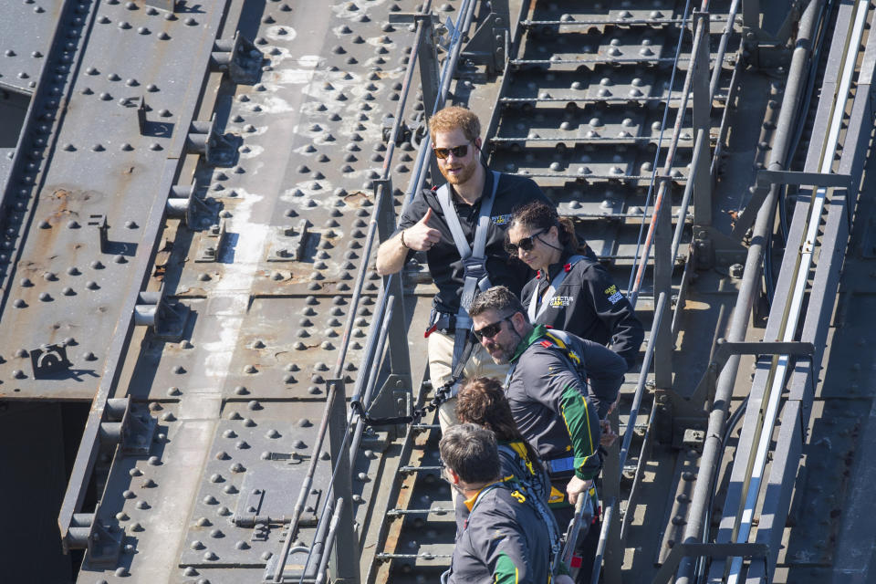 Britain’s Prince Harry, top, climbs the Sydney Harbour Bridge, along with Australian Prime Minister Scott Morrison and Invictus Games competitors in Sydney, Friday, Oct. 19, 2018. Prince Harry and his wife Meghan are on day four of their 16-day tour of Australia and the South Pacific.(Dominic Lipinski/Pool Photo via AP)