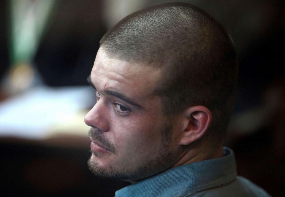 PHOTO: Joran van der Sloot looks back from his seat after entering the courtroom for the continuation of his murder trial at San Pedro prison in Lima, Peru, Jan. 11, 2012. (Karel Navarro/AP)