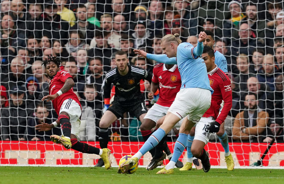 Manchester City striker Erling Haaland's shot is being blocked by Manchester United players during their English Premier League clash. 
