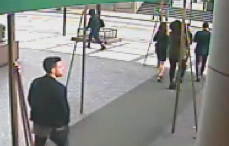 Surveillance video shows Joey Comunale, left, and Larry Dilione, upper right, as they walk the women to an Uber outside the Grand Sutton. / Credit: Prosecution trial evidence